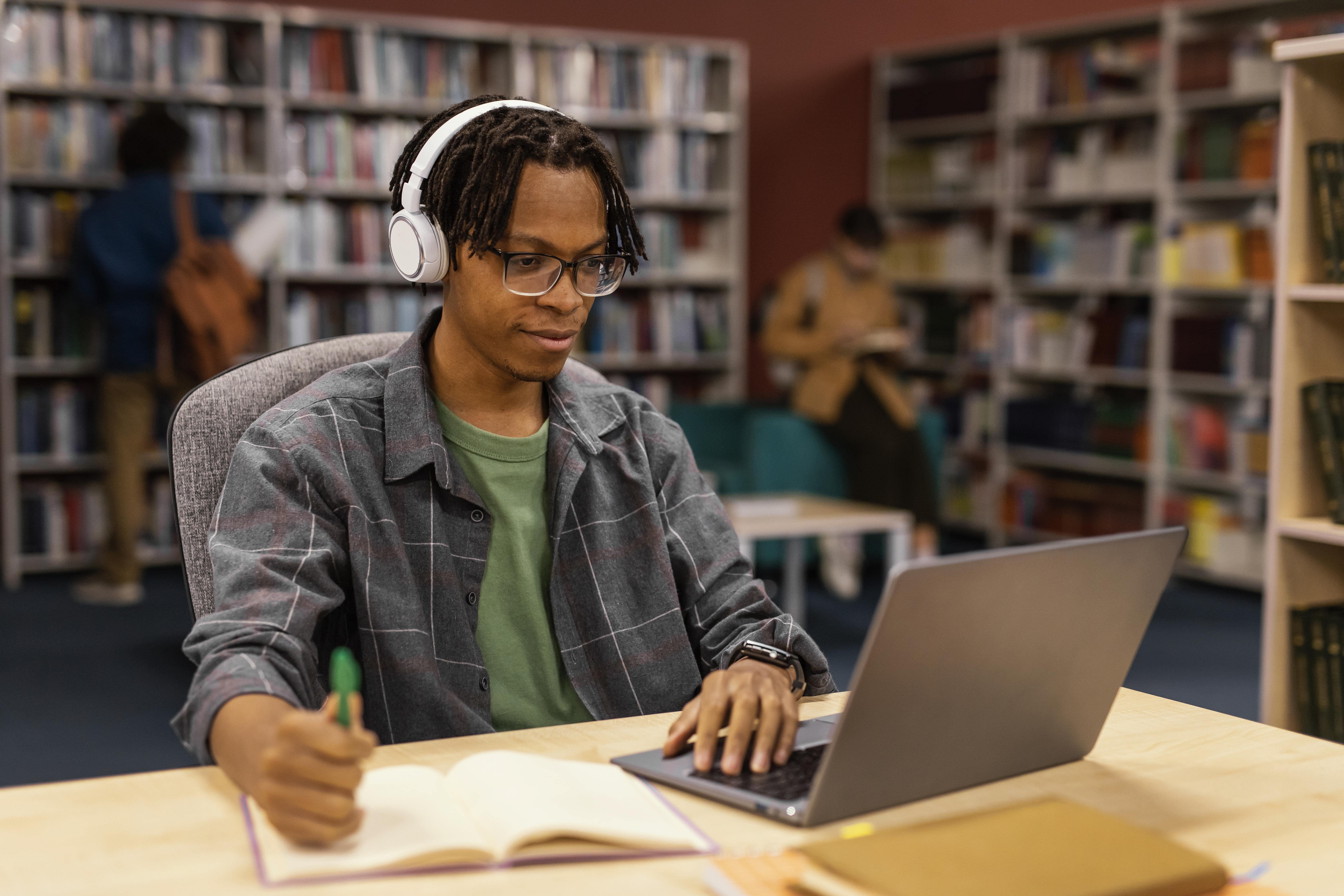 boy-studying-university-library-min