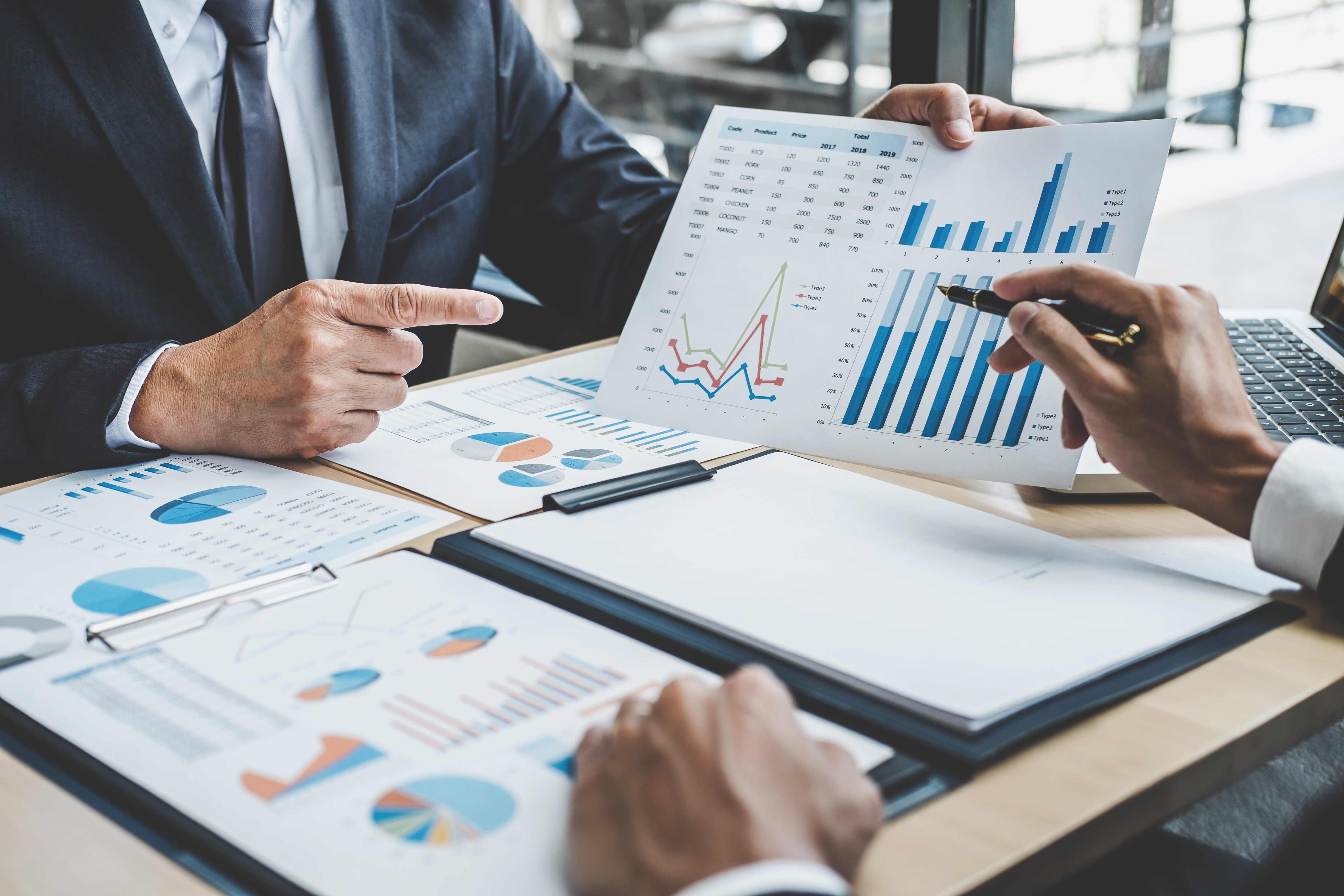 two-executive-discussing-company-growth-project-success-financial-statistics-min