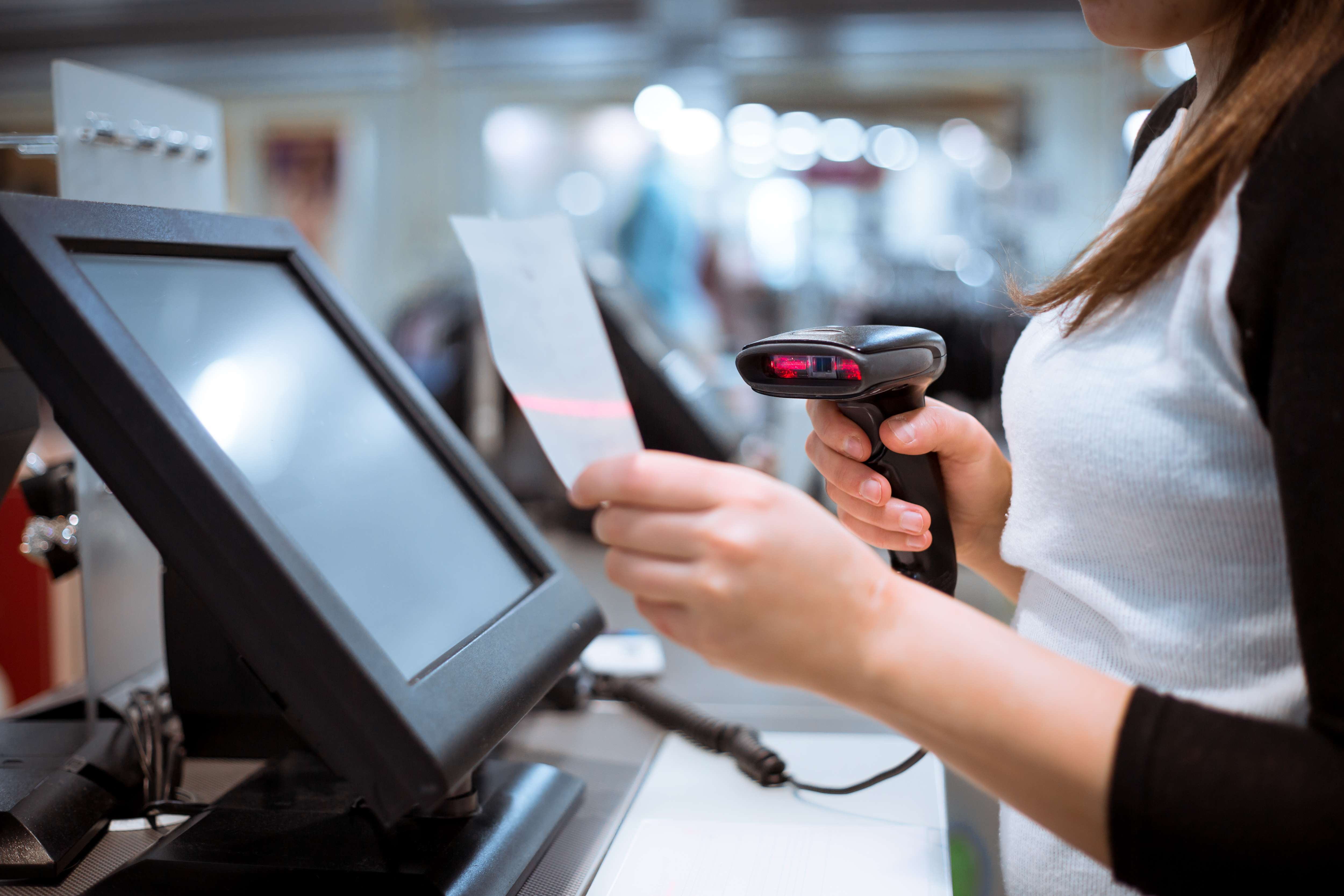 young-woman-hands-scaning-entering-discount-sale-receipt-touchscreen-cash-register-market-shop